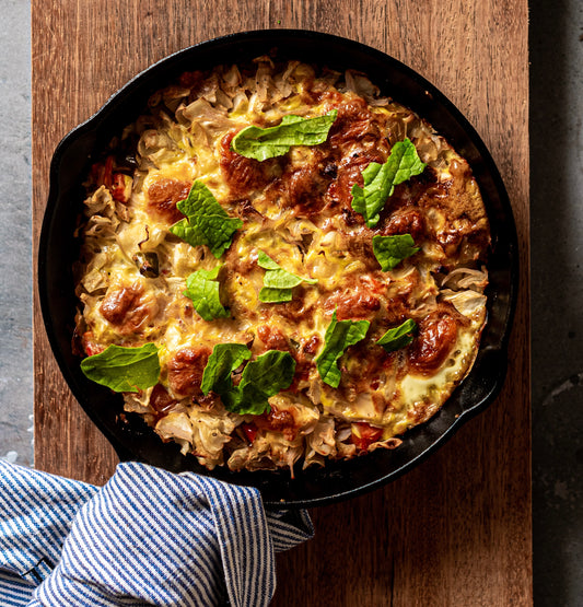 delicious food in cast iron pan on cutting board