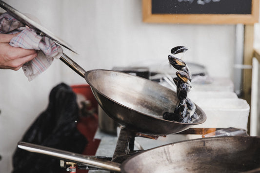 mussels cooking in a wok